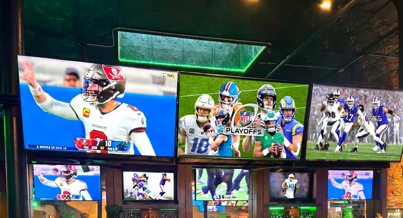 Bucs fans cheering in front of the big screens at Bad Monkey sports bar in Ybor City